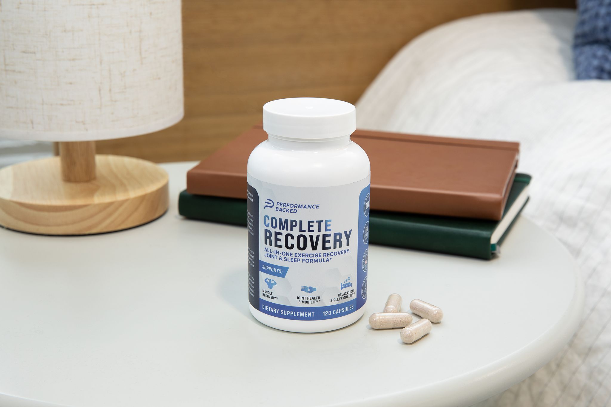 A picture of the Complete Recovery supplement sitting atop a nightstand.